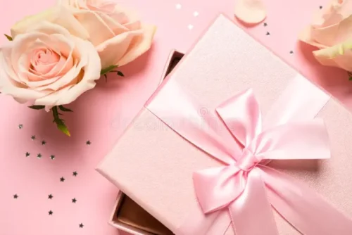 elegant gift box beautiful flowers confetti pink background flat lay 204964400